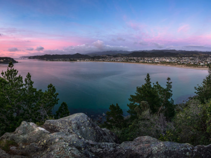 Overlooking Whangamata from the peninsula lookout during sunrise.